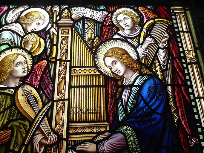 Close-up: Saint Cecelia playing the organ and three angels playing, respectively, a bowed instrument, hand cymbals, and a lyre