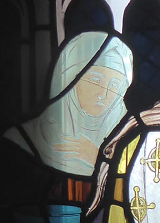 The attendant, perhaps a nun, whose painted features seem to have largely faded